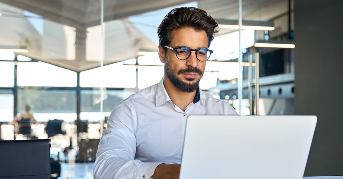 A librarian researching AI library policies on his laptop.