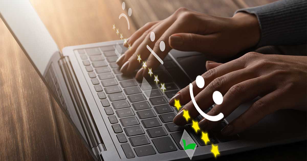 Blog post image for Thoughts on the LEXICON Framework Part 7 – Nurture feedback loops: Hands typing on a laptop keyboard with floating emoticons ranging from sad to happy, stars, and a check mark, conveying feedback or communication.