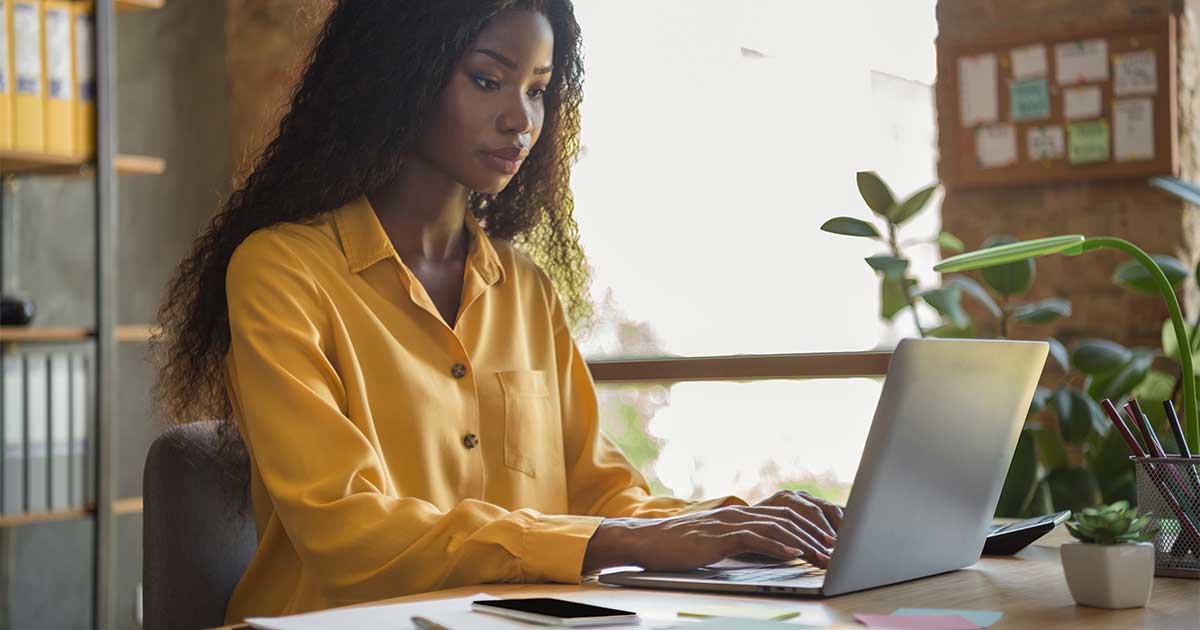A woman working on her laptop.