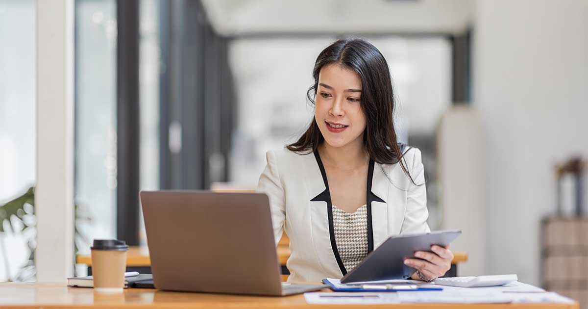 A knowledge worker reviewing information on her laptop.