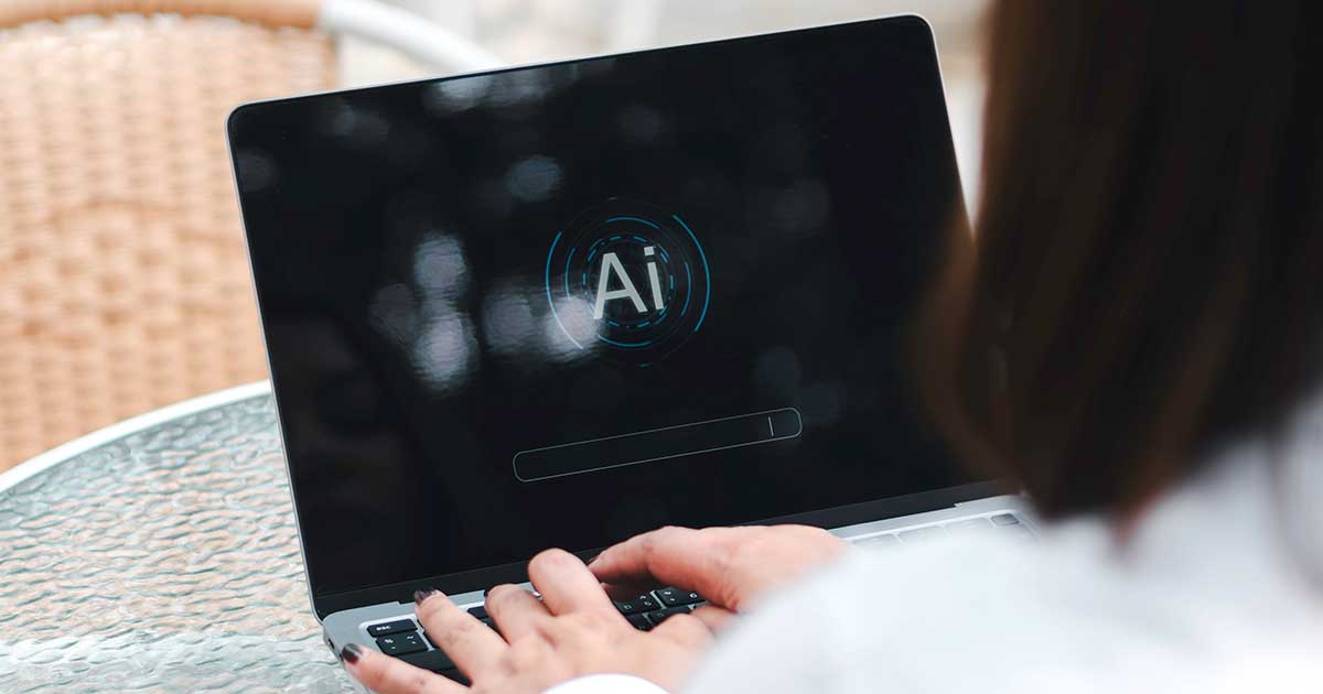 An over-the-shoulder view of a person using an AI app on their laptop.