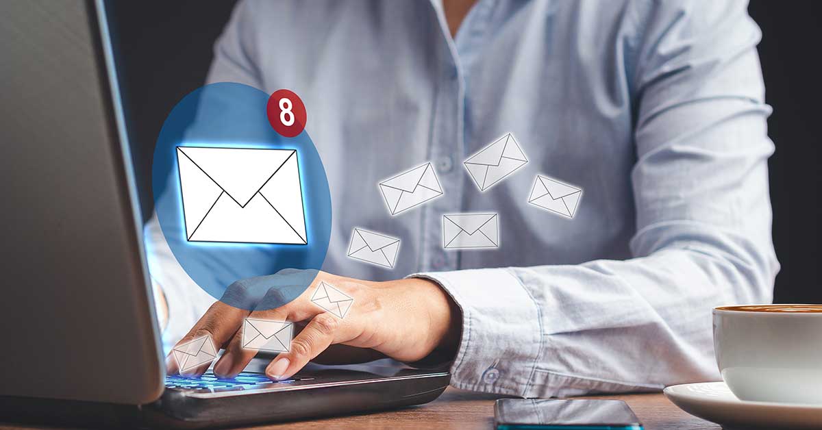 An unread email icon and several incoming message icons emerging from an open laptop.