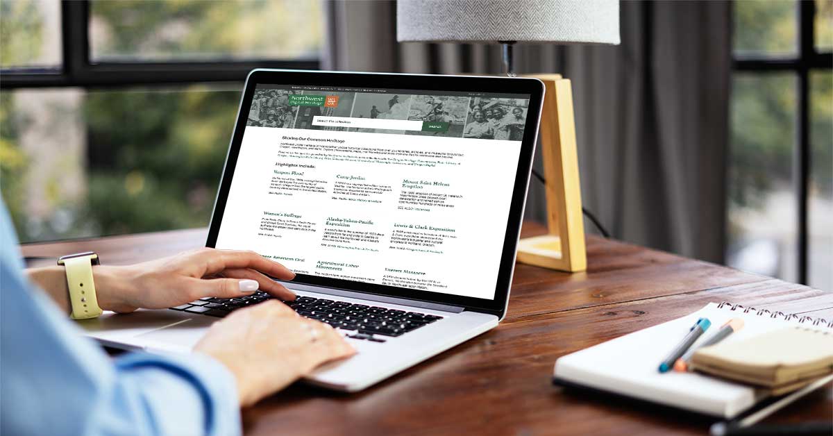 An over-the-shoulder view of someone browsing the Northwest Digital Heritage discovery portal on a laptop.