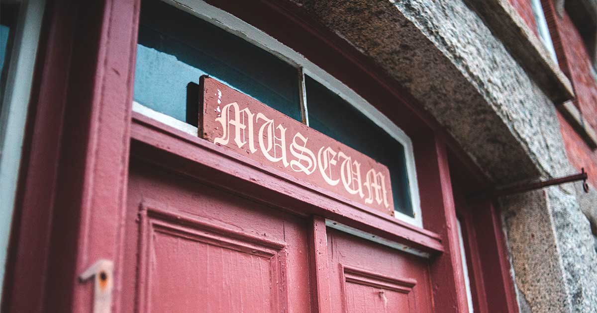 A weathered red door beneath a hand-painted 