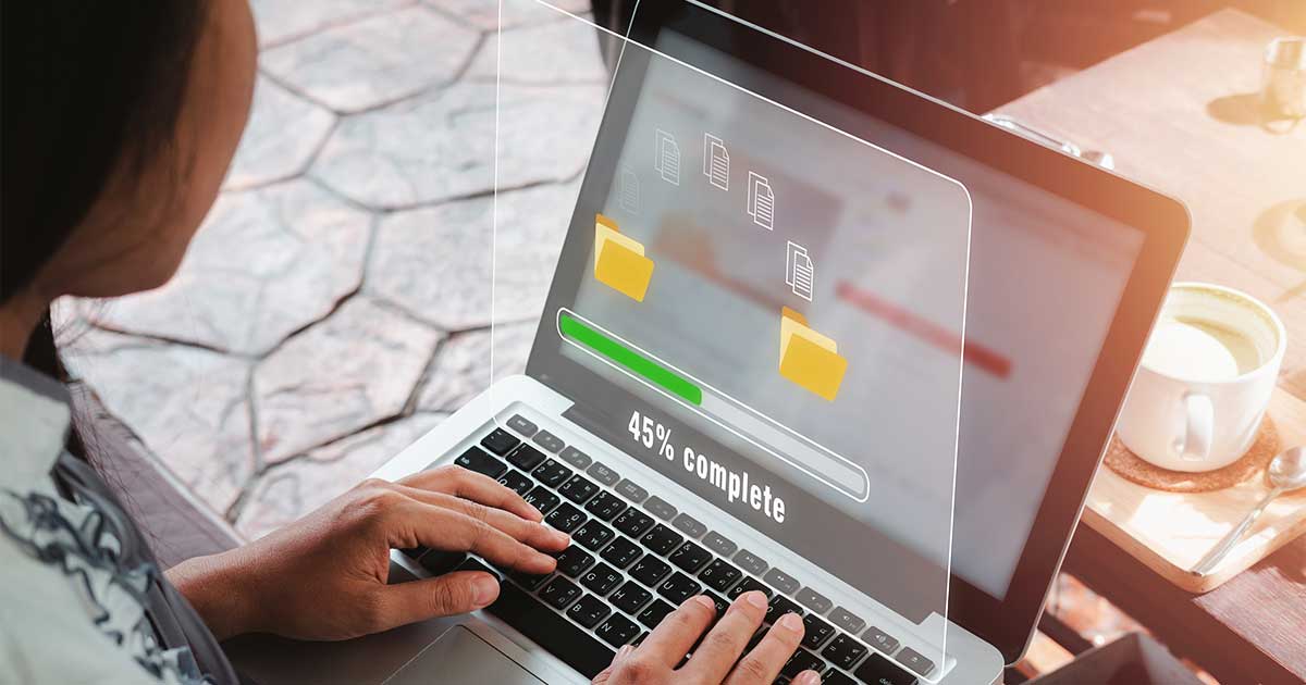 A person types on a laptop as an overlay shows files moving between folders and a progress bar at 45% complete.