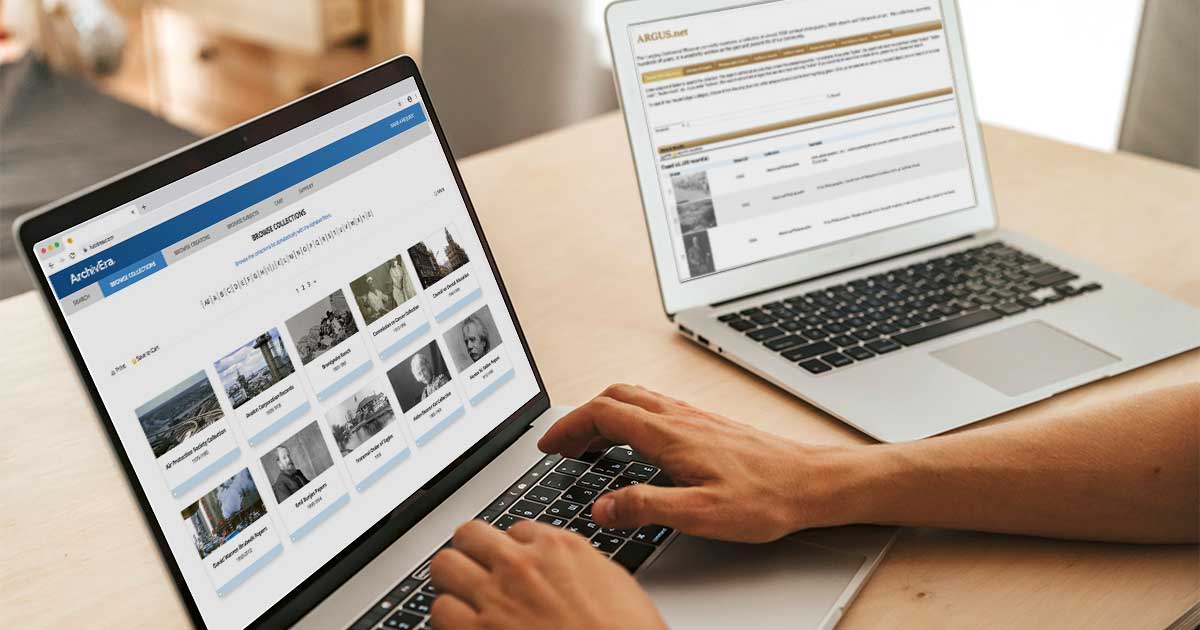 Hands typing on a laptop showing an ArchivEra portal's Browse Collections page, with a second laptop open in the background.